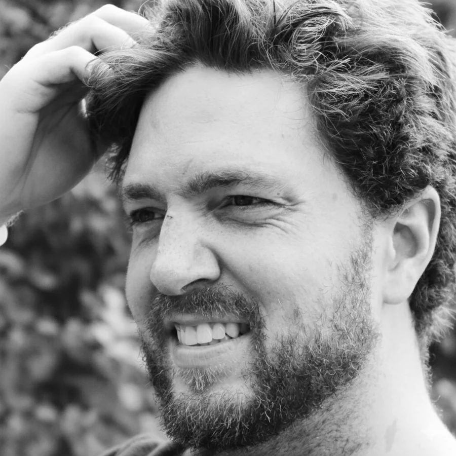 Scott Bell, smiling, in a black and white portrait
